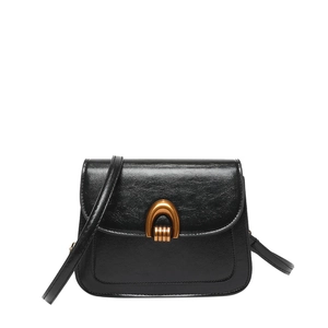 Classic black oil wax leather saddle bag with distinctive golden horseshoe buckle detail