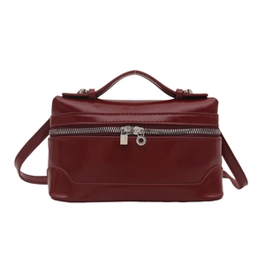 Classic red box-shaped leather crossbody bag with top handle and dual zippers