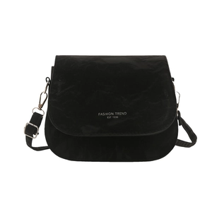 Minimalist black crossbody bag with pleated texture and silver buckles on white background