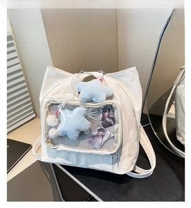 Detailed view of white nylon ita bag with transparent window and lace ribbon decoration