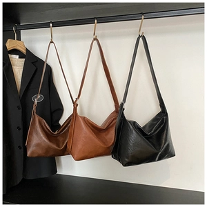 Detailed comparison of large hobo bags in dark brown, caramel, and black faux leather