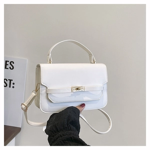 Detailed view of a white PU leather crossbody bag featuring a golden metal buckle lock