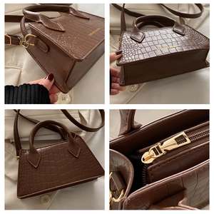 Detail view of brown crocodile pattern small square bag with premium gold hardware