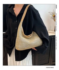 Detail of metallic gold woven hobo bag with sleek leather shoulder strap on a model