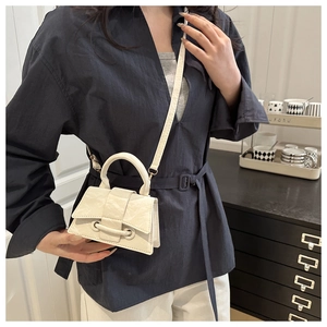 Detail of off-white mini crossbody bag with marble texture and unique bar closure