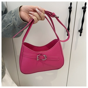 Detail of rose red leather baguette bag with silver buckle and matte vintage texture