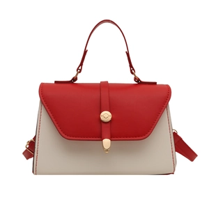 Fashionable red and white color-block crossbody bag with gold buckle and top handle