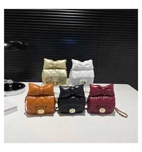 Quilted mini crossbody bags in five colors featuring large decorative bows and chain straps