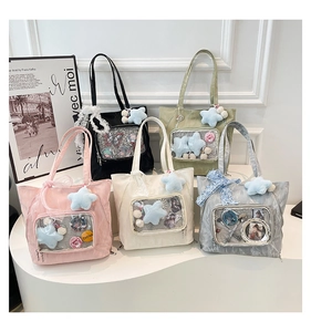 Collection of five colorful ita bags with clear display windows and decorative charms