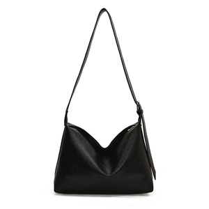 Minimalist black large capacity leather tote bag with adjustable shoulder strap and zipper