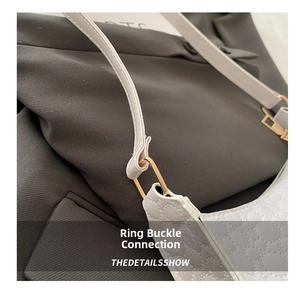 Detail of white quilted handbag with gold metal buckle and slim shoulder strap