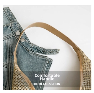 Detail of woven straw tote bag showing brown leather handle and metallic button detail