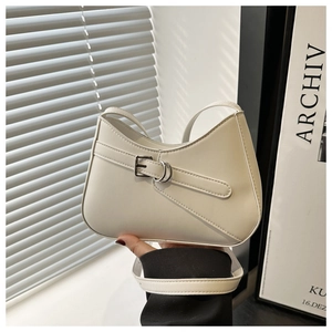 Detail shot of the minimalist cream white hobo bag showing smooth leather and belt buckle