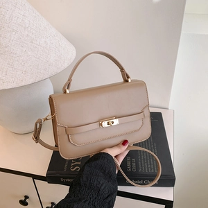 Minimalist beige leather handbag with gold twist lock and shoulder strap for daily wear