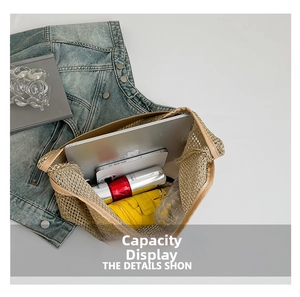 Top view of large woven straw tote bag showing spacious capacity for laptop and umbrella