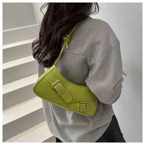 Detail of lime green underarm bag featuring dual metallic buckles and a knotted strap