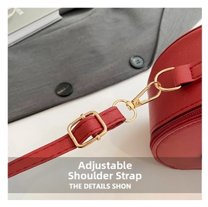 Detail of red Saffiano leather strap with golden adjustable metal buckle and lobster clasp