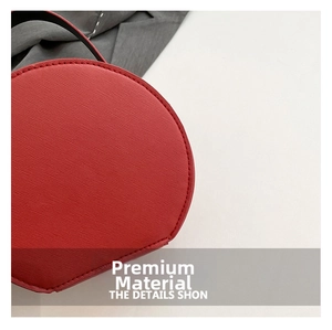 Detailed shot of red round bag showing premium Epi water ripple leather texture and stitching
