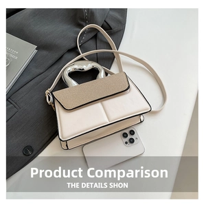 Detail of cream crossbody bag with textured fabric flap and unique silver metal handle