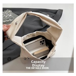 Detail view of cream PU leather shoulder bag showing interior capacity and silver studs