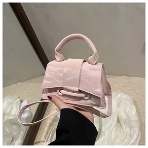 Detailed close-up of a pink textured mini handbag showing the flap and top handle