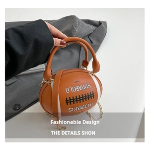 Detail of creative rugby-shaped handbag with SDIYABOLO print and golden chain strap