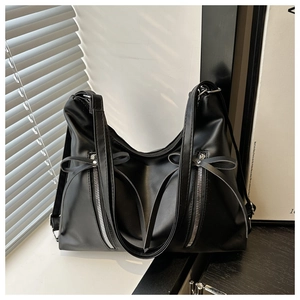 Détail du sac cabas en cuir PU noir avec doubles zips et nœuds décoratifs élégants