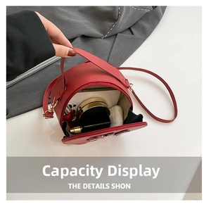 Top view of red round crossbody bag capacity showing phone, lipstick, and accessories