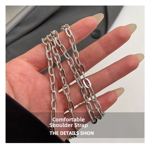Close-up of polished silver metal chain strap for stylish crossbody square bags
