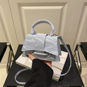 Minimalist light blue mini handbag with unique crinkled texture and gold hardware