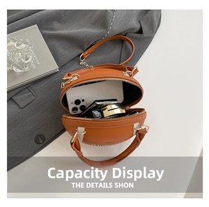 Internal view of rugby-shaped leather bag showing space for phone and makeup