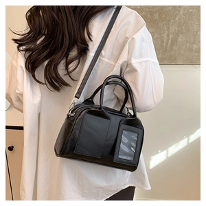 Modèle portant un sac Boston noir avec doubles poches et bandoulière réglable