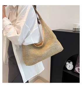 Detail of light brown woven mesh tote bag with minimalist shoulder strap for summer
