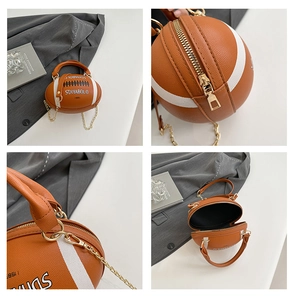 Detail view of football-shaped handbag showing leather texture, gold chain and zip closure