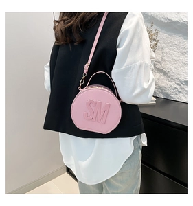 Pink round leather crossbody bag featuring 3D SM letter relief and adjustable strap