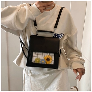 Detail of black faux leather backpack with transparent flower window and metal hooks