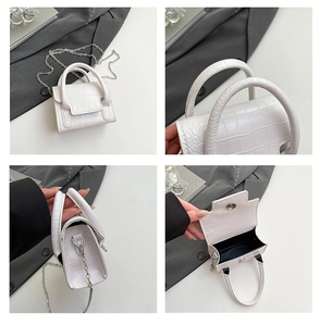 Detail of white crocodile pattern mini square bag with silver chain and magnetic closure