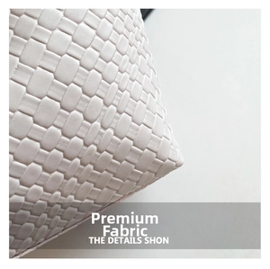 Close-up of premium beige woven faux leather texture and luxury craftsmanship on tote bag
