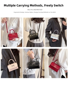 Macro detail of faux leather square crossbody bag with silver metal bow clasp