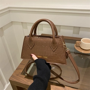 Brown crocodile pattern faux leather handbag with top handle and shoulder strap