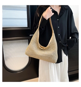 Detailed close-up of beige hollow mesh woven shoulder bag featuring textured hobo design