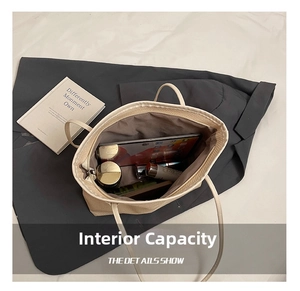 Macro view showing large capacity interior of woven tote bag with daily essentials