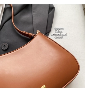 Macro detail of brown leather baguette bag with refined stitching and gold metal logo