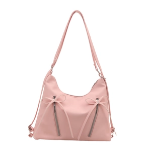 Sac fourre-tout rose avec nœuds décoratifs et fermetures éclair sur fond blanc