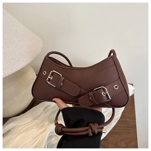 Detailed close-up of a dark brown half-moon bag with elegant gold buckle hardware