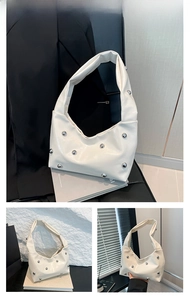 Close-up of white underarm bag featuring silver rivet studs and smooth leather texture