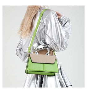 Detail of neon green contrast handbag with silver irregular metal handle and woven texture