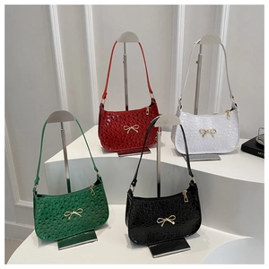 Close-up of four glossy bubble textured shoulder bags with golden bow buckles