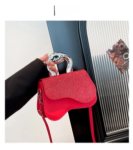 Detail of red leather crossbody bag with liquid metal handle and sparkling star sequins