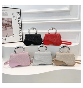Five shiny glitter shoulder bags with arched metal handles in various stylish colors